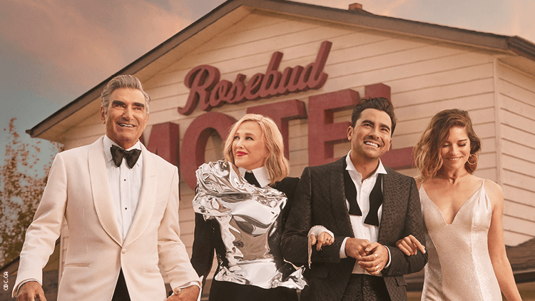 The Schitt's Creek cast in front of the Rosebud Motel