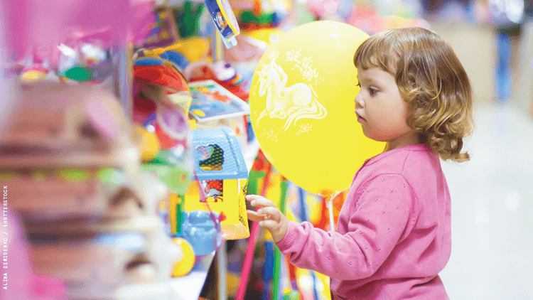 a toddler picking out toys